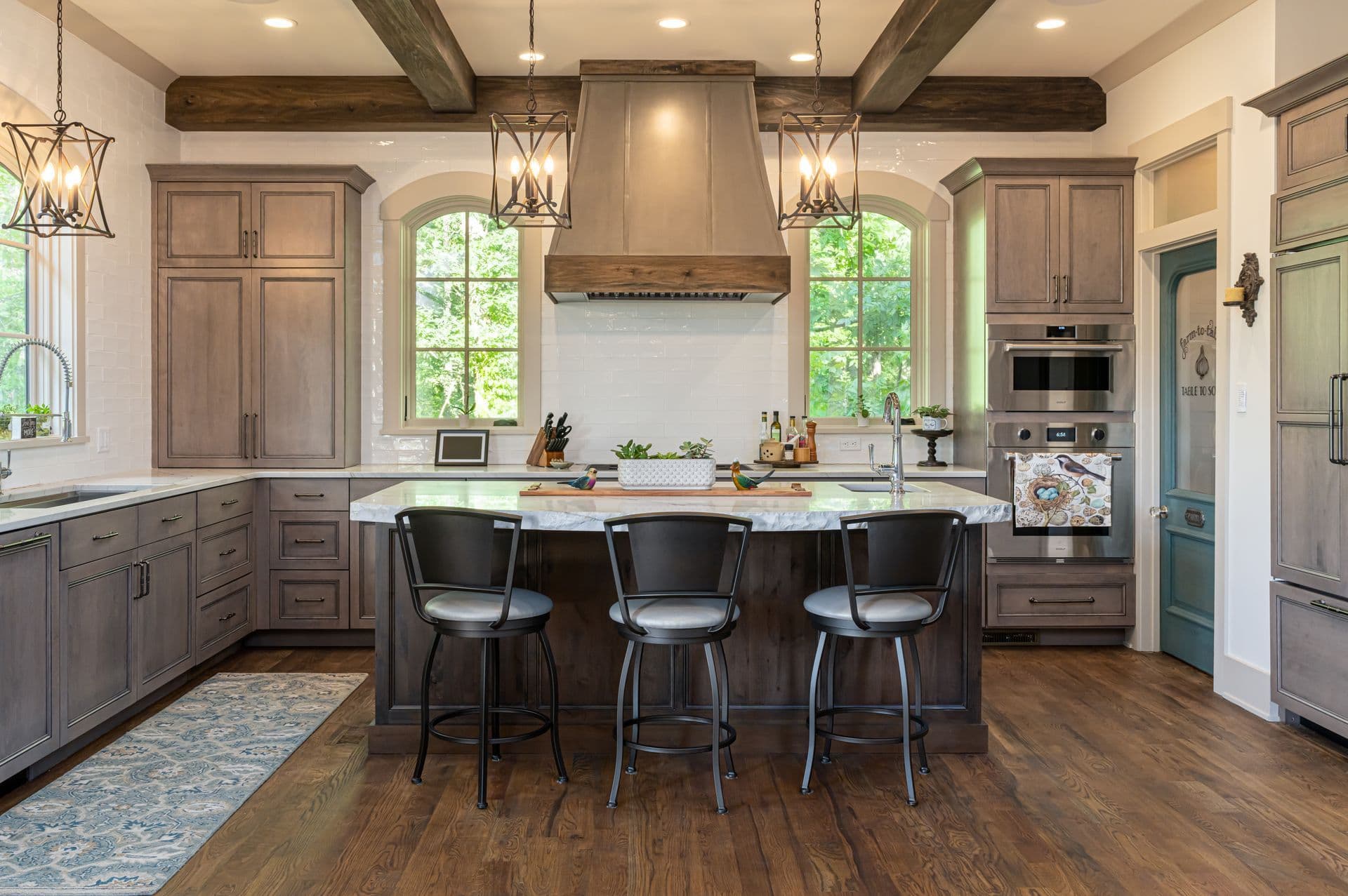 Warm French country kitchen with a central island and brass accents