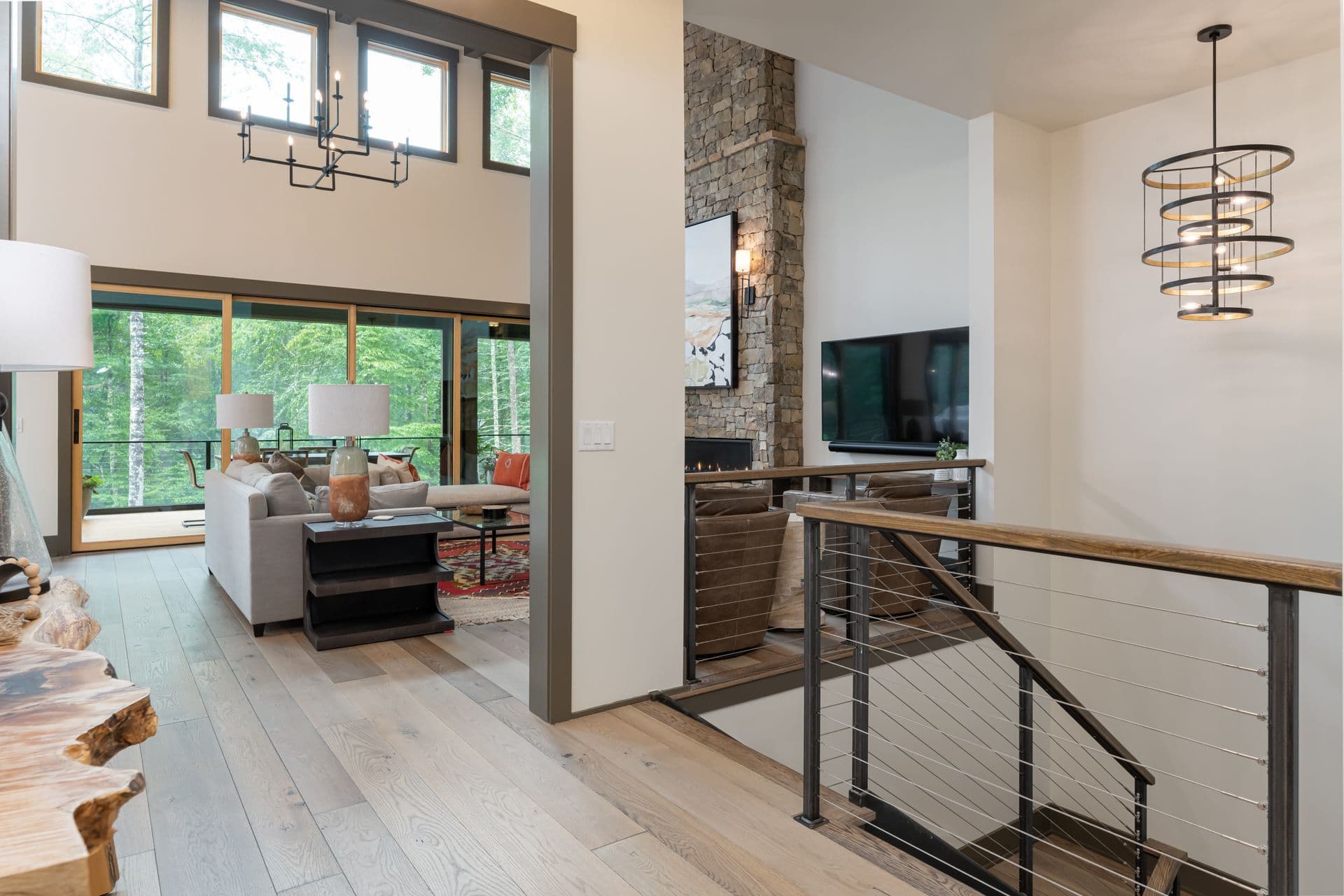 Open living space with a stone fireplace and warm timber details