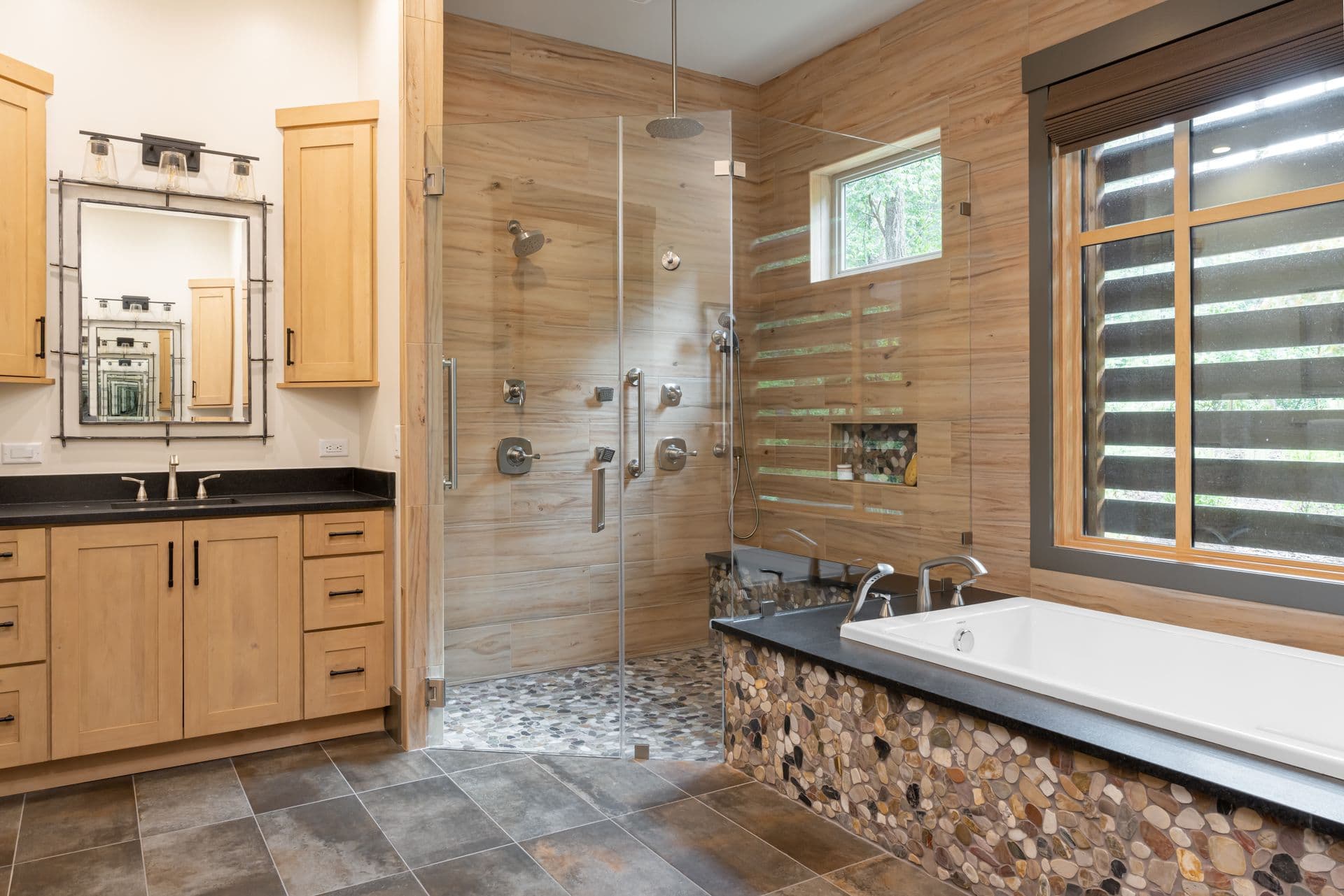 Spa-like bathroom with a soaking tub and natural stone