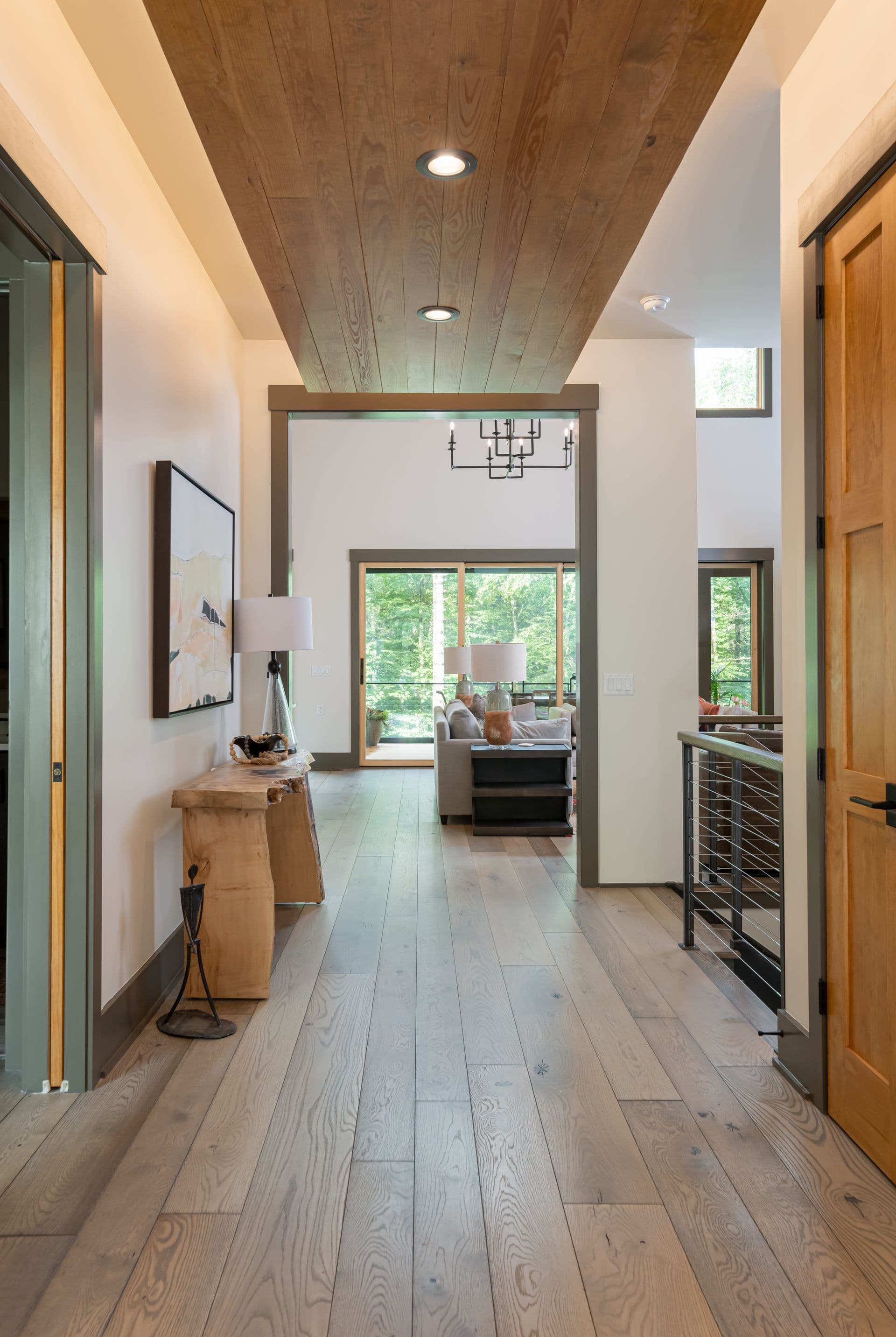 Long, light-filled hallway with warm wood accents