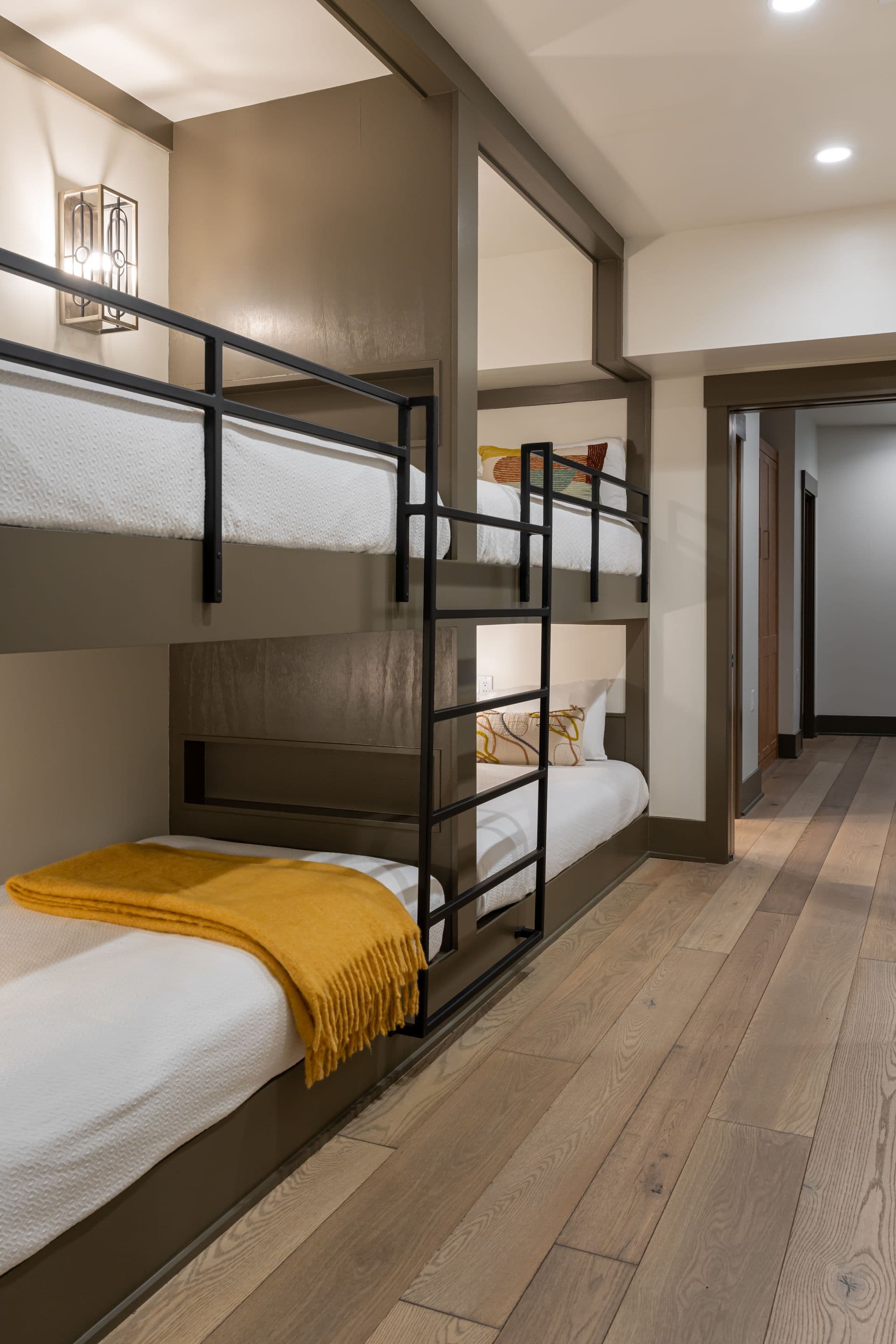Bunk room with tailored bedding and modern metal frames