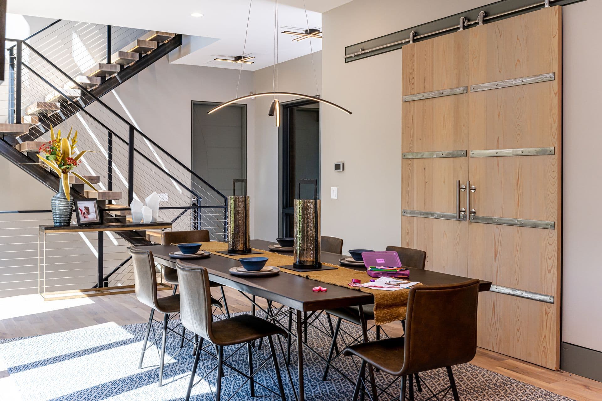 Dining area beside the staircase in a softly layered home